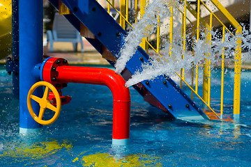 Image showing Red iron tube in pool