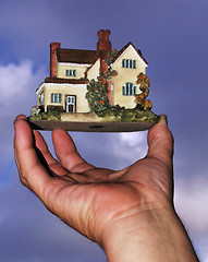 Image showing A hand holding a new house