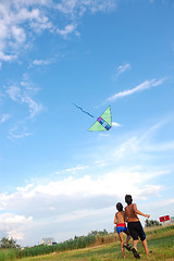 Image showing children flying kite in the sky