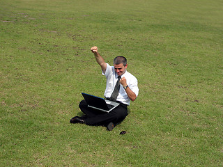 Image showing Happy man with computer in the field