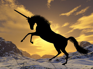 Image showing A fantastic unicorn silhouetted against the sunset