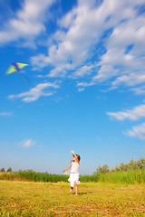 Image showing running child flying  a kite