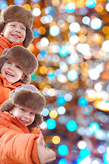 Image showing happy winter kids against colorful lights