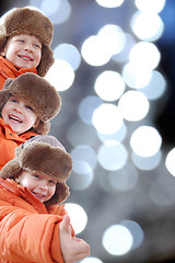 Image showing happy winter kids against colorful lights