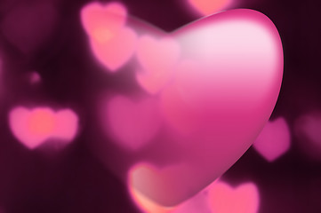 Image showing Pink heart fades into out-of-focus heart light background