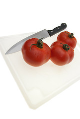 Image showing Cutting board with a knife and tomato