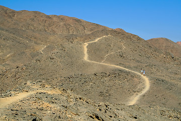 Image showing Tourists walking along a mountain path