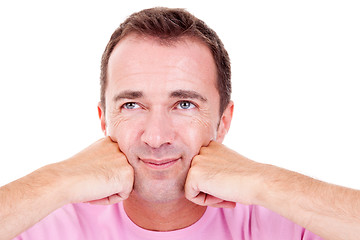 Image showing Portrait of a handsome middle-age man, with hands on the face, looking up