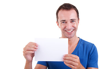 Image showing Man holding a white card, smiling and looking to camera