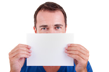 Image showing Man holding a white card in front of face, looking to camera