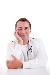 Image showing smiling middle-age man sitting at desk