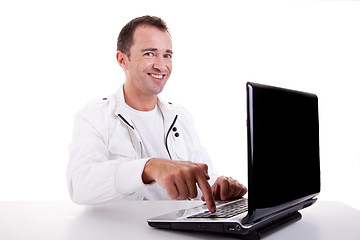 Image showing happy man looking to camera, put the finger on computer