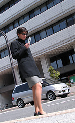 Image showing Using Mobile Phone In A Street