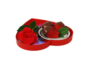 Image showing Strawberries in chocolate on red heart shaped tray with rose