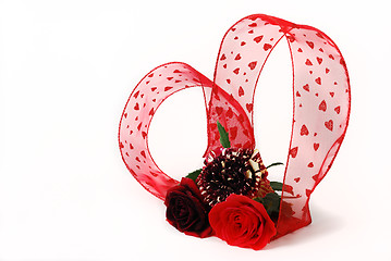 Image showing Three different red tint roses with heart shaped  ribbon