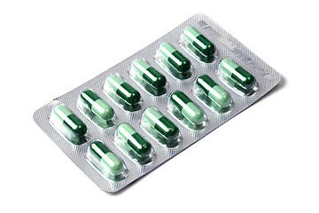 Image showing Package of green capsules  isolated on white