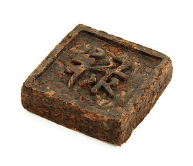 Image showing Pressed briquette of green tea with hieroglyphic on white backgr