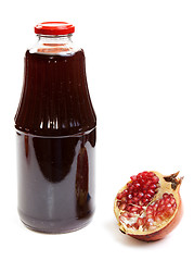 Image showing Bottle of juice and ripe piece grenade