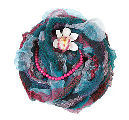 Image showing Varicoloured scarf is put with necklace around and flower