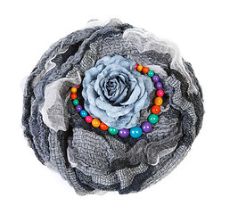 Image showing Varicoloured scarf is put with necklace around and flower