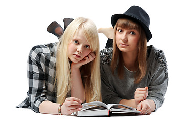 Image showing Two girls lies and read books