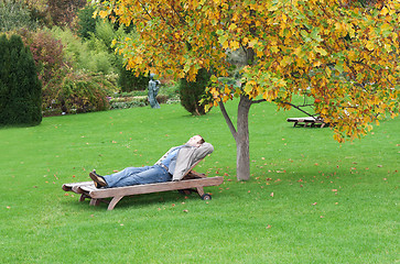Image showing A man, lying on a lounger