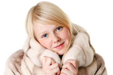 Image showing Blonde girl with blue eyes wearing a fur coat