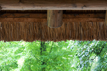 Image showing Reedy roof with wooden log