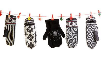 Image showing Winter knitted gloves hang