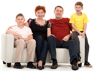 Image showing Family of four on a sofa