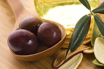 Image showing pasta, black olives, oil with fresh branch. food ingredients 