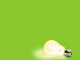 Image showing green Background with lit lightbulb