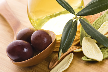 Image showing pasta, black olives, oil with fresh branch. food ingredients