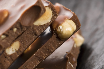 Image showing Pile of broken chocolate with nuts 