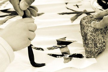 Image showing Teacher Helping Student drawing hieroglyph