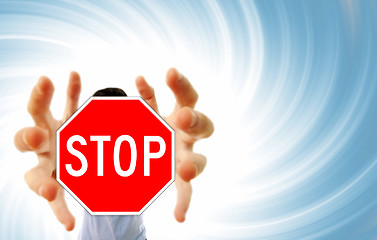 Image showing Man grabing a stop sign