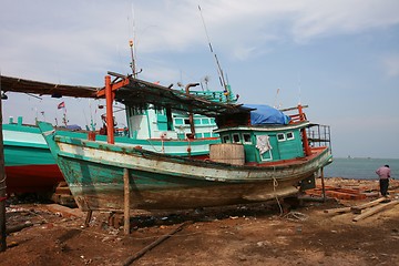 Image showing Fixing a fishing boat