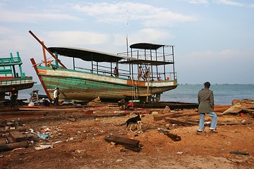 Image showing Fixing a fishing boat