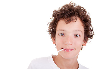 Image showing Cute Boy with a candy on mouth smiling