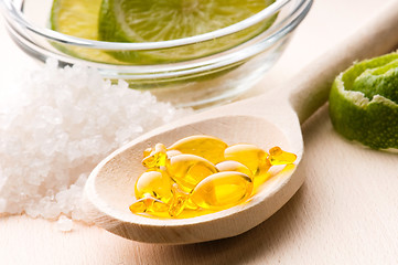 Image showing lemon bath - bath salt, capsule and fresh fruits