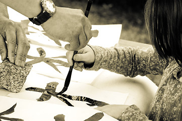 Image showing Teacher Helping Student drawing hieroglyph