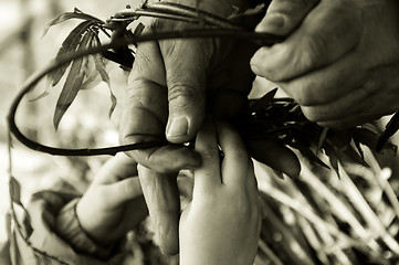 Image showing Man teaching child making a wicker basket