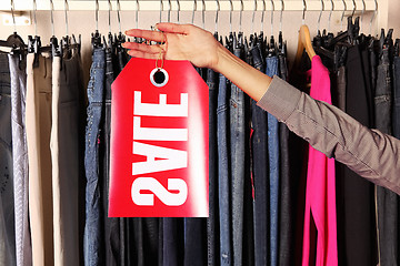 Image showing hand with sell letters plate in a store