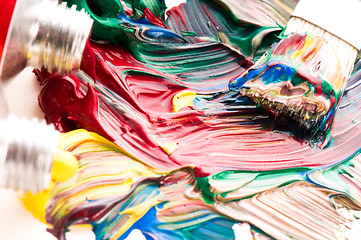 Image showing Brush mixing paint on palette