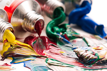 Image showing Brush mixing paint on palette