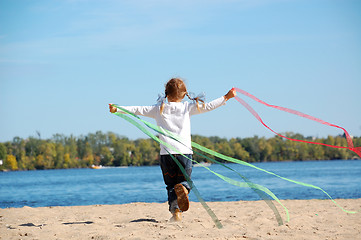 Image showing child running and playing with ribbons