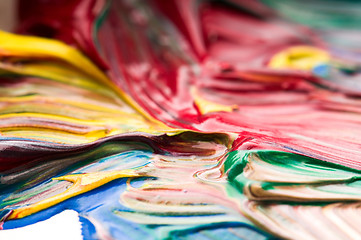 Image showing Brush mixing paint on palette 