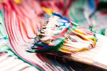 Image showing Brush mixing paint on palette