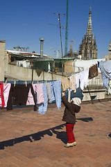 Image showing portrait of a sweet girl with the clothesline. urban scene