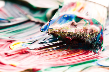 Image showing Brush mixing paint on palette 